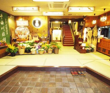 Genkan entrance with slippers and floral displays, Central Hotel, Nagano Chūbu Japan