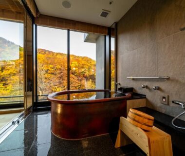 Copper soaking tub and shower with autumn mountain view at Chalet Ivy Jozankei in Hokkaidō