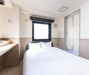 Small bright double room with bed, desk, window and ensuite bathroom at Chang Tee Hotel Ikebukuro Tokyo