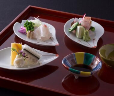 Assorted Japanese appetizers on lacquer tray with tea bowl at Charoku Bekkan Kyoto