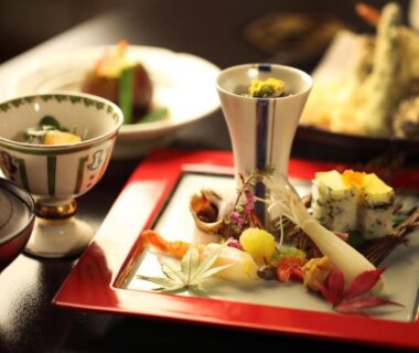 Lacquer tray with assorted Japanese dishes, ceramic bowls and tempura at Chigira Jinsentei in Gunma