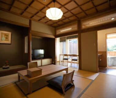 Spacious tatami room with low table, shoji screens and sliding doors at Chigira Jinsentei, Gunma Kanto