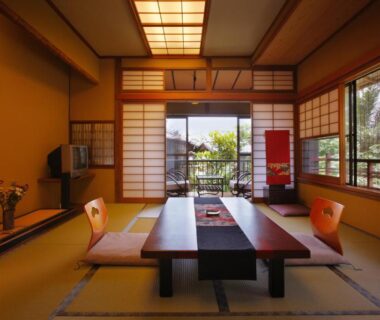 Traditional tatami room with shoji screens and low dining table overlooking garden