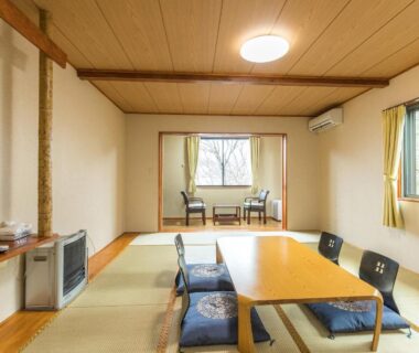 Tatami room with low table, cushions and window seating at Chojuyu Hakone, Kanagawa