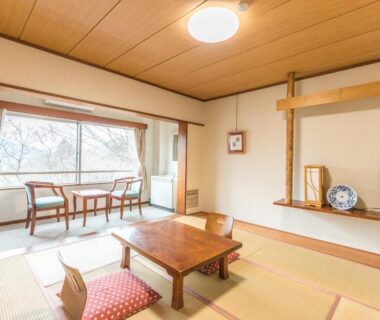 Bright tatami room with low table, cushions, window seating and wooden ceiling at Chojuyu Hakone, Kanagawa
