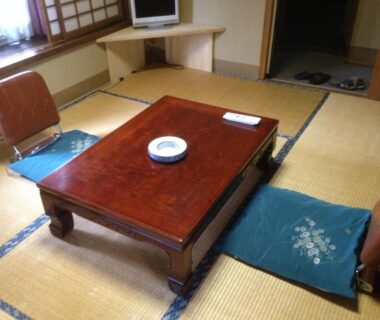 Tatami room with low table, zaisu chairs and shoji window at Chuokan Shimizuya Ryokan in Nagano, Chūbu, Japan