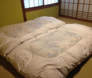 Two futon mattresses on tatami floor in a guest room at Chuokan Shimizuya, Nagano