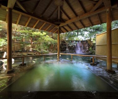 Roofed stone onsen with waterfall backdrop at Club Wyndham Chikumakan Nagano, Nagano, Chūbu Japan