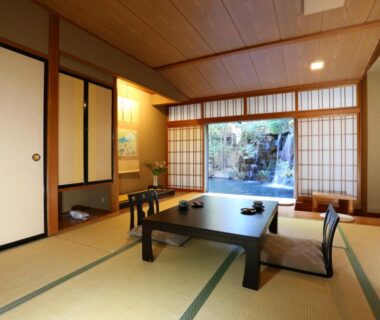 Traditional tatami room with low table and shoji screens opening to a garden at Club Wyndham Chikumakan Nagano