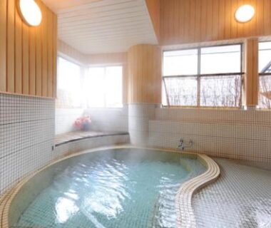 Curved tiled bath with windows at Dai Onsen Matsudaya in Iwate Tohoku