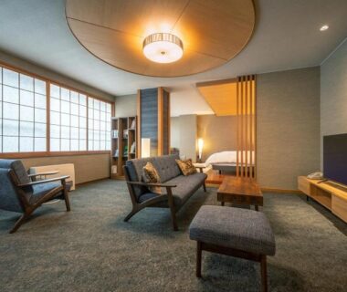 Modern Japanese sitting room with shoji screens and lounge chairs at Dai Onsen Matsudaya, Iwate