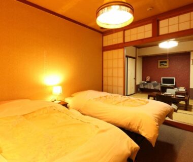 Twin beds on tatami with shoji screens and low table at Dai Onsen Matsudaya Ryokan Iwate Tōhoku