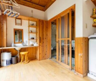 Wood-paneled changing area with vanity, stool and washing machine at Daitokuji Sushicho, Kyoto Kansai