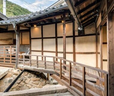 Covered wooden corridor and bridge over stone courtyard at Takeda Castle Town Hotel in Hyōgo, Kansai