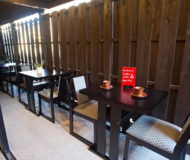 Wooden terrace with tables and tea cups at Ebisu Ryokan Kyoto