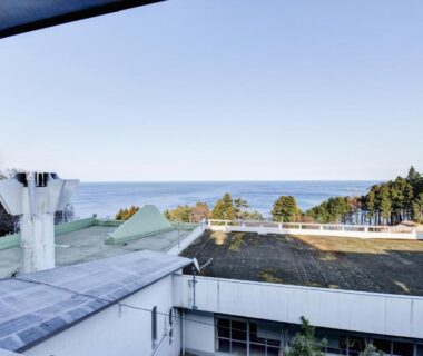 Rooftop terrace with distant coastline, treeline and rooftops in Iwate, Japan