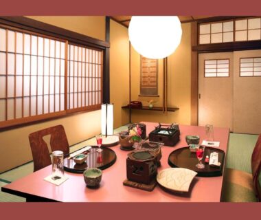 Tatami room with low dining table and shoji screens at Ekinariya Ryokan in Gunma, Kantō