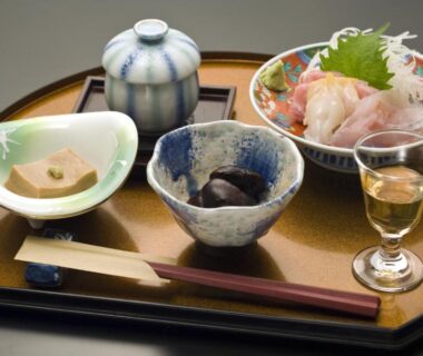 Sashimi and small dishes on a lacquer tray at Ekinariya Ryokan in Gunma