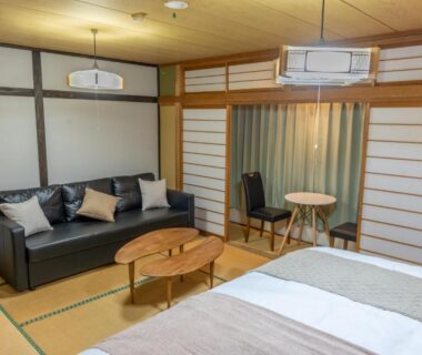 Tatami room with beds, sofa and shoji screens at Elan Hotel Lake Nojiri, Nagano