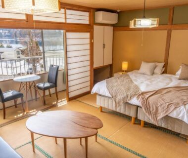 Tatami mat room with twin beds, shoji screens, low table and balcony seating at Elan Hotel Lake Nojiri Nagano