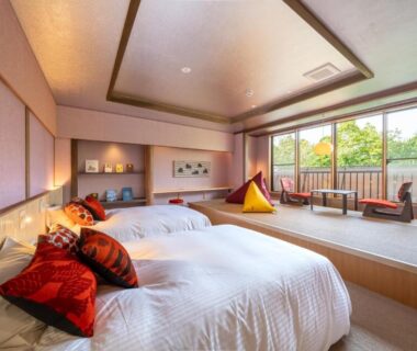 Twin beds on raised platform with balcony at Enokiya Ryokan in Oita, Kyushu, Japan