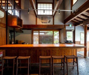 Interior wooden counter and stools with high beam ceiling at Enokiya Ryokan, Oita, Kyushu