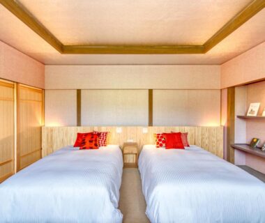 Twin beds on tatami floor with shoji screens at Enokiya Ryokan in Oita