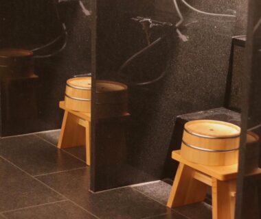 Wooden wash stools and buckets in bathing area at Exclamation Hotel Hokkaidō Japan