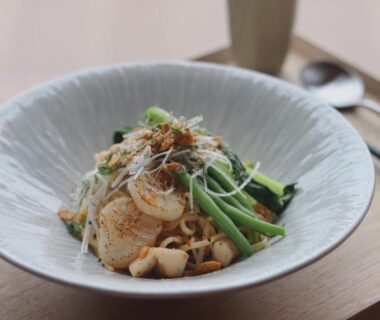 Seafood and greens in ceramic bowl on wooden tray at Exclamation Hotel Hokkaido dining