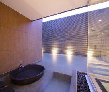 Round indoor soaking tub by glass wall at Four Seasons Yuzawa Quattro in Niigata