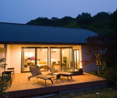 Wooden terrace with lounge chairs and sliding glass doors at Fugaku Gunjo, Shizuoka