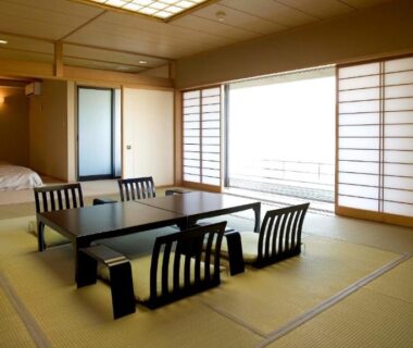 Traditional tatami room with low table, zaisu chairs, shoji screens and futon area at Fugaku Hanabusa, Shizuoka
