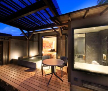 Outdoor wooden terrace with bathtub and seating at Fuji Onsenji Yumedono Yamanashi