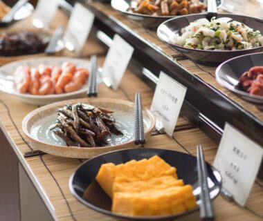 Assorted Japanese breakfast dishes on buffet counter including tamagoyaki, shrimp and small plates at Fuji View Hotel, Yamanashi