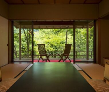 Traditional tatami room with low table and veranda overlooking lush garden at Fujiiso, Nagano, Chūbu