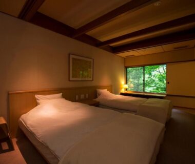 Twin beds on tatami with sliding window showing greenery, Fujiiso ryokan, Nagano Chūbu