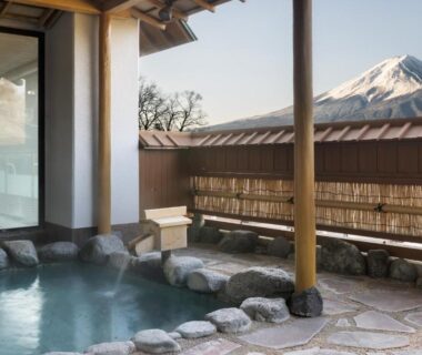 Stone-edged outdoor onsen with Mount Fuji view at Fujikawaguchiko Onsen Konanso, Yamanashi