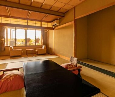 Traditional tatami room with low table, floor chairs, shoji screens, alcove at Fujiya in Ishikawa
