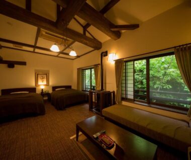 Twin room with exposed wooden beams and garden view at Fujiya in Kumamoto, Kyushu