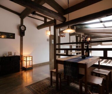 Interior wooden dining area with beams and low table at Fujiya Ryokan, Kumamoto, Kyushu