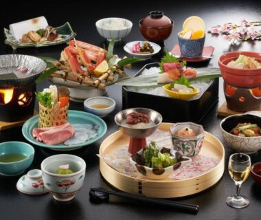 Assorted Japanese dishes with crab, sashimi, lacquerware, and sake at Fujiya ryokan in Niigata, Chubu, Japan