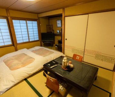 Traditional tatami room with futon, low table, shoji screens and tea set at Fujiya Ryokan Kyoto