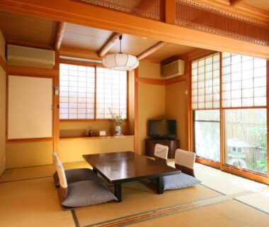 Traditional tatami room with shoji screens, low table and floor cushions at Fukashiso in Nagano