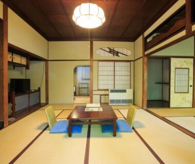 Traditional tatami room with low table, zabuton cushions and shoji screens at Fukuzumiro, Kanagawa