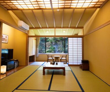 Tatami room with low table, shoji screens and garden view at Fulsato in Iwate, Tohoku