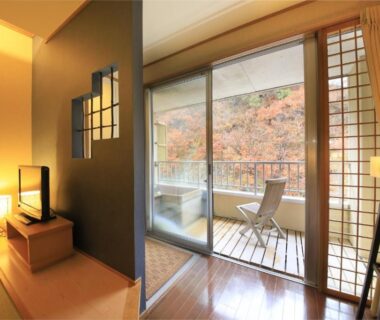Tatami room with balcony and chairs, Fulsato ryokan overlooking Iwate hillside foliage