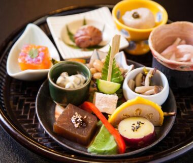 Small ceramic bowls and plates arranged on lacquer tray at Fumoto Ryokan, Kumamoto