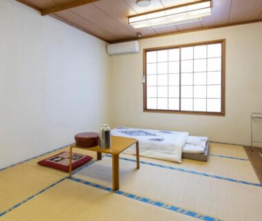 Tatami room with futon, low table and shoji window at Fureaihouse Shiodu no Sato, Niigata