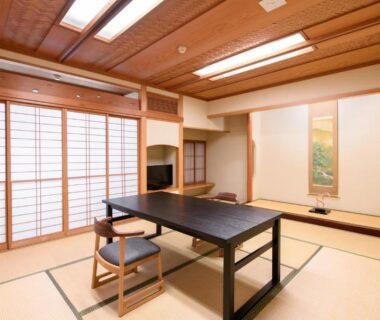 Tatami room with low table, shoji screens and tokonoma at Furuya Ryokan in Shizuoka