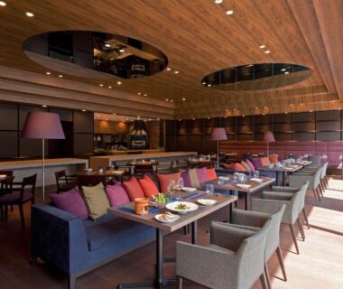 Modern lounge with sofas and dining tables at Furuyu Onsen Oncri in Saga, Kyushu, Japan